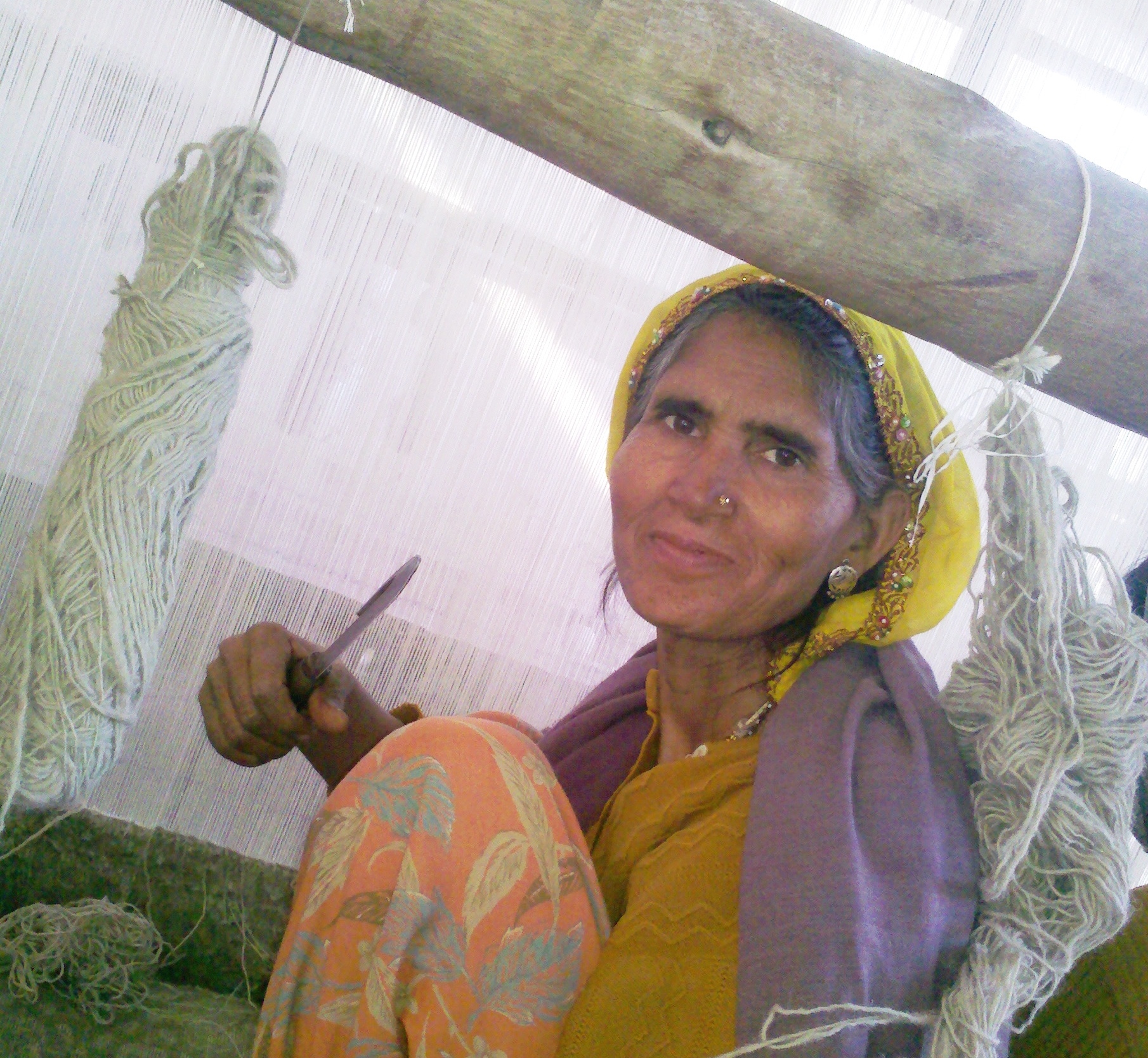 Passion and dedication of a female carpet weaver